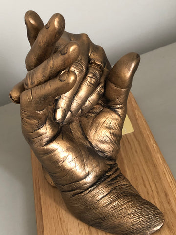 Hands clasped (2 adults)