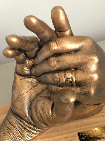 Hands clasped (2 adults)