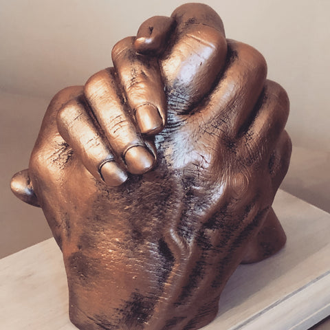Hands clasped (2 adults)