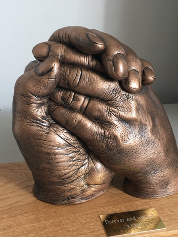 Hands clasped (2 adults)