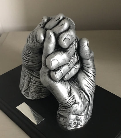 Hands clasped (2 adults)